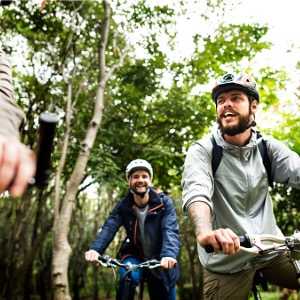 group-of-friends-ride-mountain-bike-in-the-forest-together-picture-id951396750